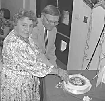 Cyril and Marion Brown cutting the cake at their Diamond Wedding celebration.